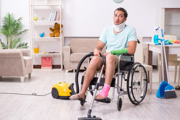 Young man in wheel-chair cleaning the house