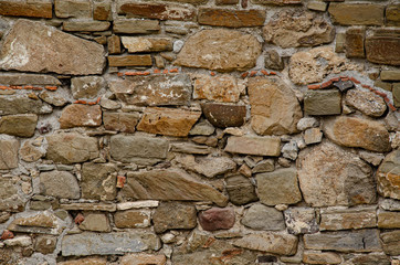 Ancient wall made of natural stones, ancient ruins.