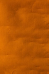 Real orange canvas with wrinkles as a background.