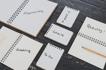 setting up for success, business desk with notebooks with elements from planning to scheduling tasks and getting results