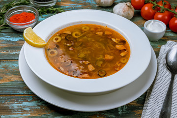 Meat Solyanka soup on wooden table