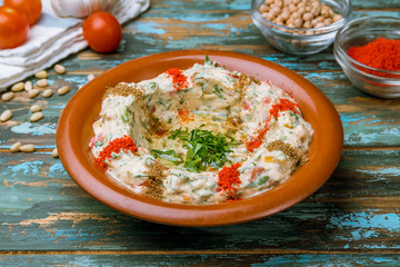 Traditional homemade hummus on wooden table