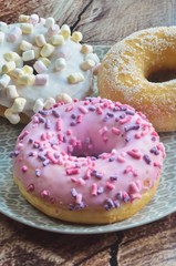 Sweet colorful dessert. Donut with a hole and pink delicious icing.