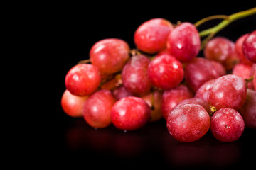 Bunch of big red grapes isolated on a black background