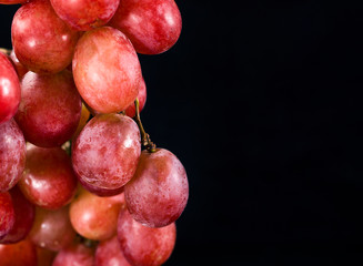 Bunch of red grapes isolated on a black background