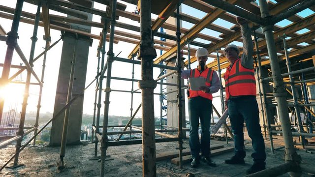 Construction workers are discussing the building site