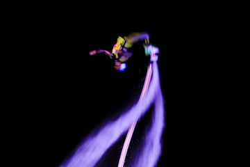 Water stunts performance at night in a park