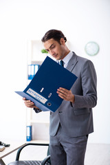 Young male accountant working in the office