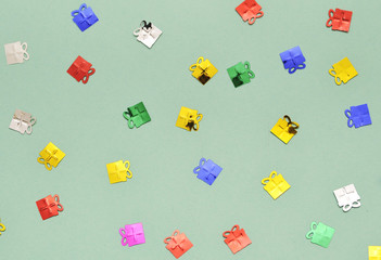 Festive background. Colorful glitter stars on mint color background.