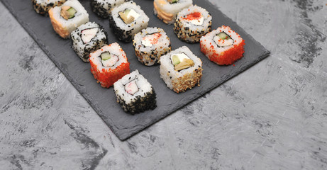 Japanese rolls on stone background.