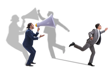 Businessman shouting through large loudspeaker