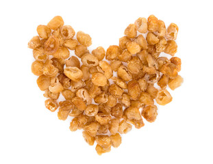 dried longan fruit making a heart shape isolated on white background