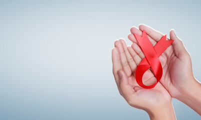 Healthcare and medicine hands holding ribbon