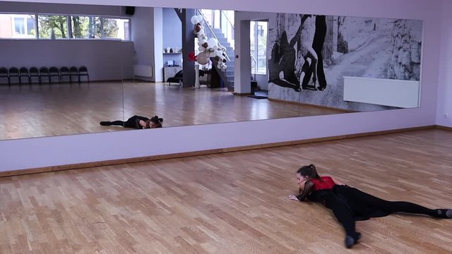 Slow motion female dancer spinning in front of the mirror