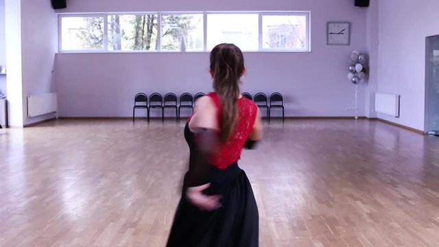 Professional and passionate female dancer dances on the dance floor