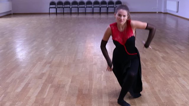 Professional and passionate female dancer dances on the dance floor