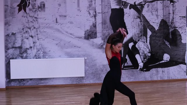 Professional and passionate female dancer dances on the dance floor