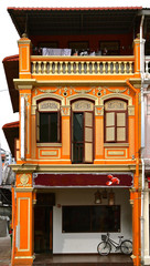 Orange restored peranakan Chinese shop house.