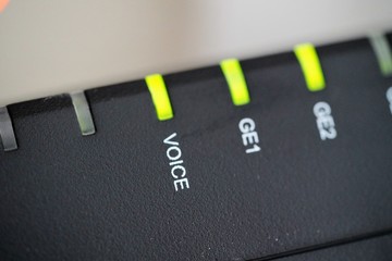 macro view on internet router with sign VOICE ance green neon leds