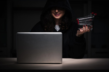 Female hacker hacking security firewall late in office