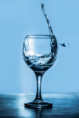 Glass of marti Glass of martini splash on a blue backgroundni splash on a blue background