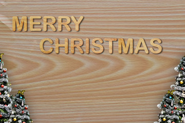 Obraz na płótnie Canvas Sign symbol Christmas Tree and Word character on wooden background. Empty copy space for inscription. Idea of merry christmas