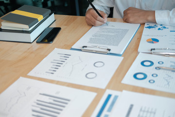 businessman investor signing contract agreement document with business partner. closing deal in...