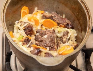 Lamb meat is fried in a pan