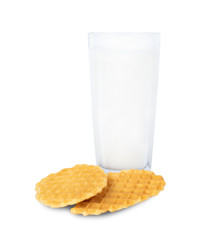 Oval wafer cookies and crumbly milk on a separate table on a white background