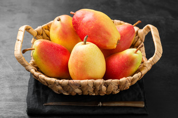 Fresh ripe organic pears on a black wooden table