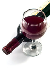 Glass and bottle of red wine on a white background