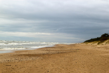 Fototapeta na wymiar Stormy weather on the baltic sea beach with beautiful clouds
