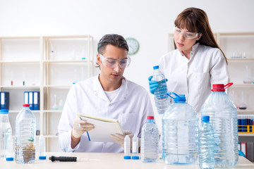 Two chemists working in the lab