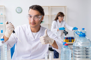 Two chemists working in the lab