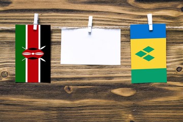 Hanging flags of Kenya and Saint Vincent And The Grenadines attached to rope with clothes pins with...