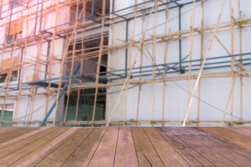 Top desk with blur scaffolding bamboo background,wooden table
