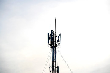 Telecommunication, Cell phone towers, are located on the Top of the Building with Cloudy Blue Sky background