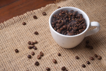 cup full of coffee beans with smoke like a hot coffee
