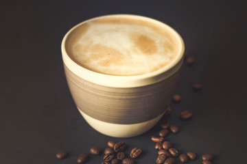 Cup of coffee and coffee beans on a Black Table