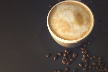 Cup of coffee and coffee beans on a Black Table