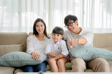 happy family watching TV entertainment together in living room at holiday time weekend, keep watching and teach family member in appropriate content