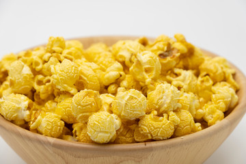 Butter caramel popcorn in wooden bowl bulk on white background, Popular snack with favorite movie