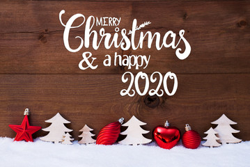 Fototapeta na wymiar English Calligraphy Merry Christmas And A Happy 2020. Red Christmas Decoration Like Tree And Ball Ornament. Wooden Background With Snow
