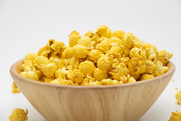 Butter caramel popcorn in wooden bowl bulk on white background, Popular snack with favorite movie