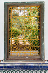 Detail of yellow decorative fence of a window of the Bahia palace in Marrakech. Morocco