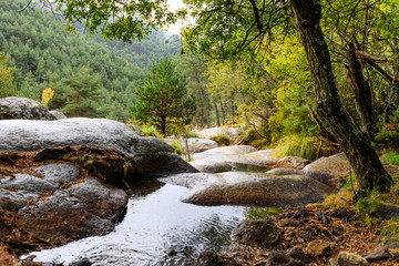 River with First fall colors in the mountains of Madrid, Spain