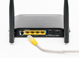 Black wireless router with local area network cable isolated on white background