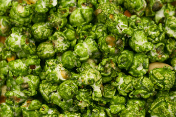 Fototapeta premium Lush of Japanese matcha green tea popcorn for texture background, Popular snack with favorite movie