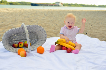 Girl eating fruit on the beach