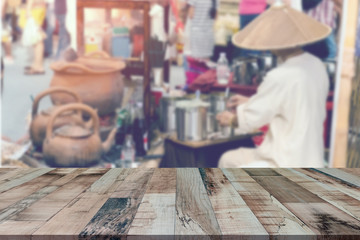 Top desk with blur ancient coffee shop in Northern of Thailand background,wooden table